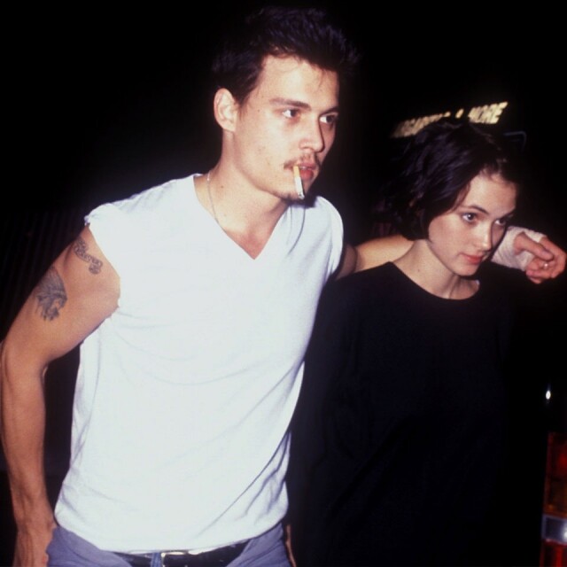 不羈的 Johnny Depp 在 90 年代穿著純白 T-shirt 搭著當時女友 Winona Ryder 的肩膀